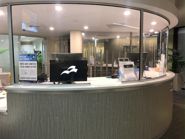 Photo of a customer service front counter, displaying a screen programmed with customer presenting software